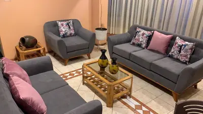 a living room with two couches and a table at Hotel SKY in Lima