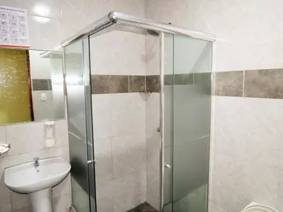 a bathroom with a shower and a sink at HOTEL ESTRELLA in Lima