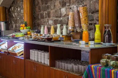 a buffet of food and drinks on a table at Hotel Monasterio San Pedro in Cusco