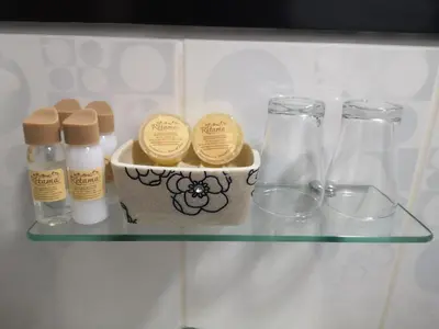 a glass shelf with bottles and glasses on it at Hotel Retama Machupicchu in Machu Picchu