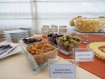 a table topped with bowls of different types of food at Qorianka Hotel in Lima