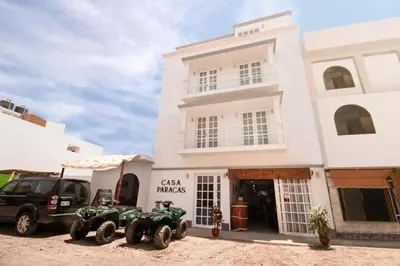 two atvs parked in front of a building at Casa Paracas in Paracas