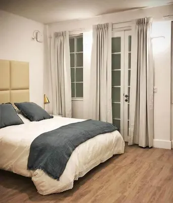 a bedroom with a large bed with a gray blanket at Casa Paracas in Paracas