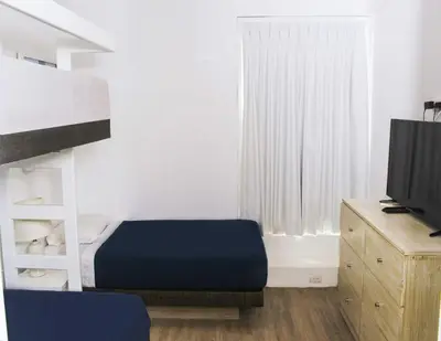 a living room with a bed and a tv at Casa Paracas in Paracas