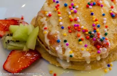 a plate with a donut with sprinkles and a strawberry at El Mariscal Cusco in Cusco