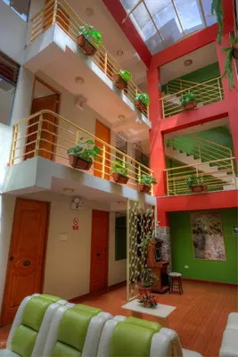 a living room with a staircase in a building at El Mariscal Cusco in Cusco