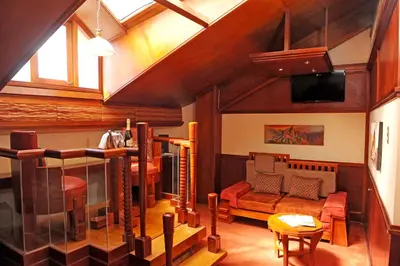 a living room with a couch and a tv at Hotel Waynapicchu in Cusco
