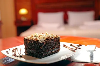 a piece of chocolate cake on a plate on a table at Hotel Waynapicchu in Cusco