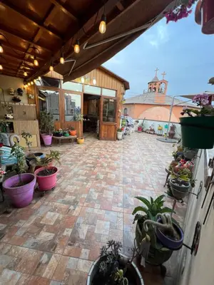 an outdoor patio with potted plants and a building at Lima Airport Tampu in Lima