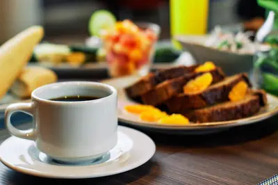 a cup of coffee and a plate of breakfast food at Xima Lima San Isidro in Lima