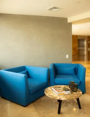 a blue couch and a table in a room at Xima Lima San Isidro in Lima