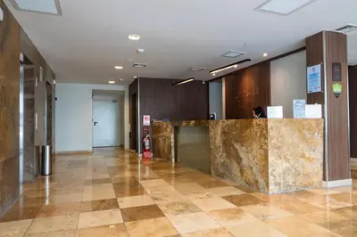 a lobby with a marble counter in a building at Xima Lima San Isidro in Lima