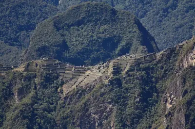 a terraced mountain side with a village on the side at Maison Fortaleza in Cusco