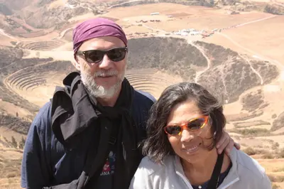 a man and a woman standing in front of a mountain at Maison Fortaleza in Cusco