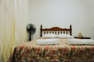 a bedroom with a bed with two pillows on it at Hospedaje El Velero in Paracas