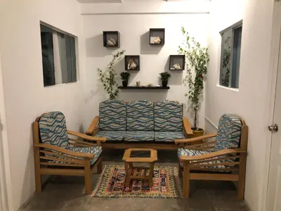 a living room with a couch and two chairs at BUGANVILIA in Paracas