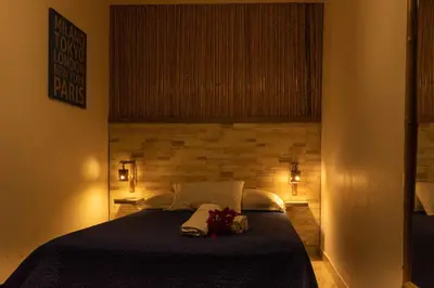 a bedroom with a large bed with lights on it at BUGANVILIA in Paracas