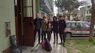 a group of people standing outside of a building at Samanai Wasi in Lima