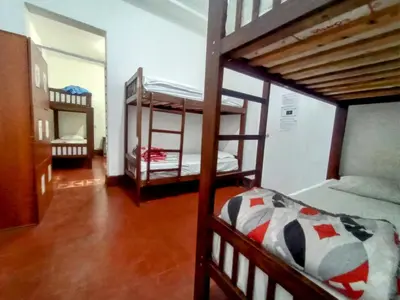 a room with two bunk beds and a mirror at Samanai Wasi in Lima