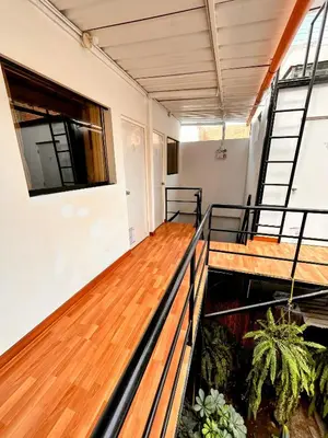 a balcony with wooden flooring in a building at Samanai Wasi in Lima