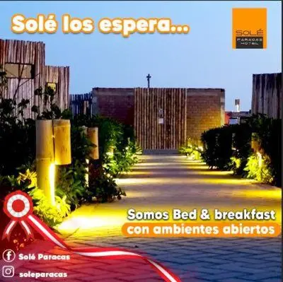 a poster of a street with a scooter parked on a sidewalk at Solé Paracas in Paracas