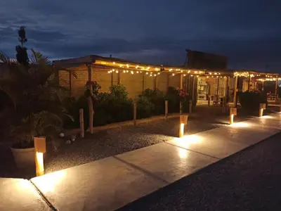 a row of lights on a patio at night at Solé Paracas in Paracas