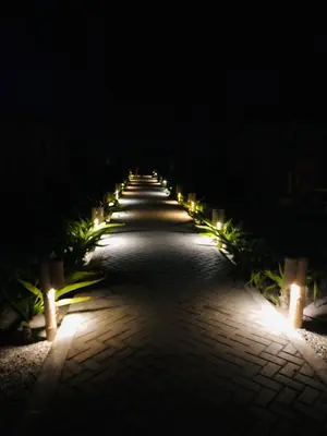 a row of lights on a walkway at night at Solé Paracas in Paracas
