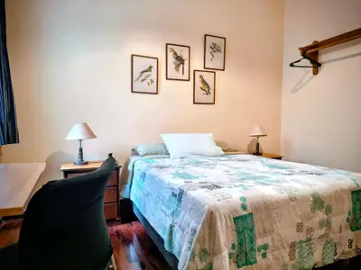 a bedroom with a bed and a desk and a chair at La Casona Azul in Lima