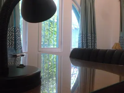 a room with windows and a couch and a table at La Casona Azul in Lima