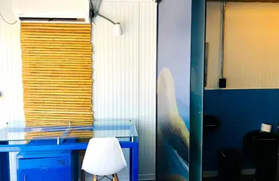 a blue desk with a white chair in a room at Surfari Punta Rocas in Punta Negra