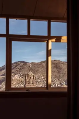a view of a city from a window at MOAF Cusco Boutique Hotel in Cusco