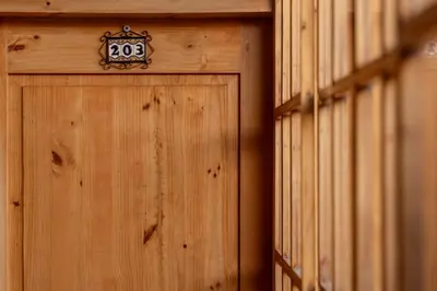 a wooden door with a clock on top of it at MOAF Cusco Boutique Hotel in Cusco