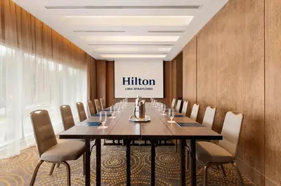 a conference room with a long table and chairs at Hilton Lima Miraflores in Lima