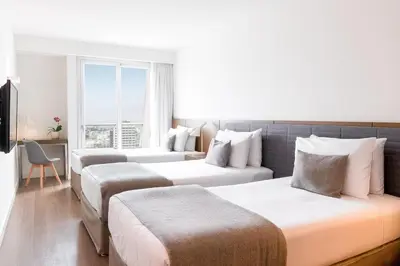a hotel room with two beds and a window at Dazzler by Wyndham Lima San Isidro in Lima