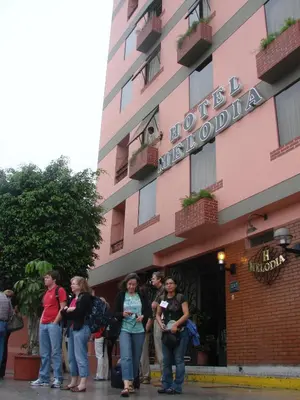 a group of people standing outside of a hotel at Hotel Melodia in Lima