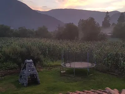 a trampoline in the grass next to a field at Mágico lugar en el Valle Sagrado in Cusco