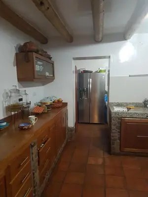 a kitchen with a stainless steel refrigerator at Mágico lugar en el Valle Sagrado in Cusco