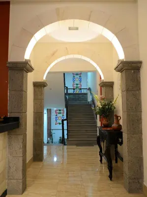 an archway leading to a staircase in a building at Altipacha Ayacucho Hotel in Ayacucho