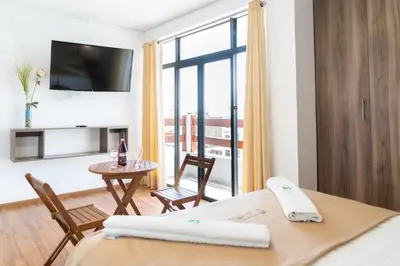 a hotel room with a bed and a view of a room at Hotel Residencial Los Frayles in Paracas
