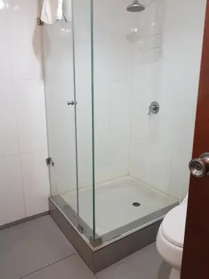 a shower with a glass door in a bathroom at Maywa at Central Miraflores in Lima