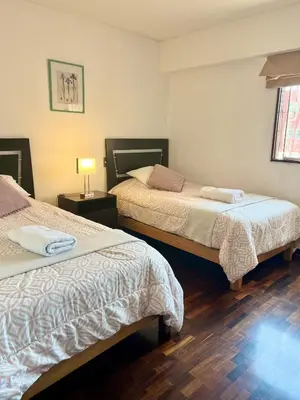 a hotel room with two beds and a lamp at Maywa at Central Miraflores in Lima