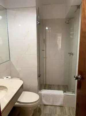 a bathroom with a shower and a toilet and a sink at Maywa at Central Miraflores in Lima