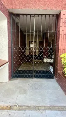 a metal gate in a brick building at Maywa at Central Miraflores in Lima