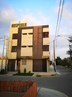 a building on a street with a hospital at Hospedaje Villa Del Sol in Ica