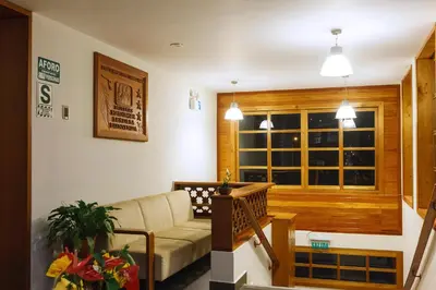 a living room with a couch and a window at Hotel Heidinger in Oxapampa