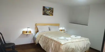 a bedroom with a bed with two towels on it at Casa Anais y Nicolas económico in Cusco
