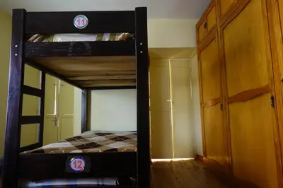 a bedroom with a bunk bed in a room at Secret Garden in Cusco