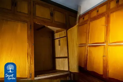 a room with wooden cabinets and a sign in it at Secret Garden in Cusco
