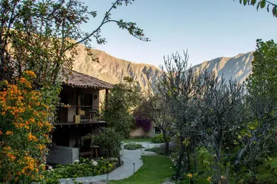 a house with a mountain in the background at Andenia Boutique Hotel, Sacred Valley in Urubamba