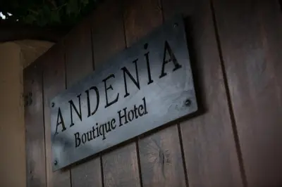 a sign on the side of a wooden wall at Andenia Boutique Hotel, Sacred Valley in Urubamba